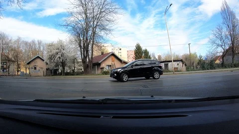 943-04 Car Ride Dashboard Center View Exiting Parking Lot And Ride Onto Main Str Stock Footage 105664595