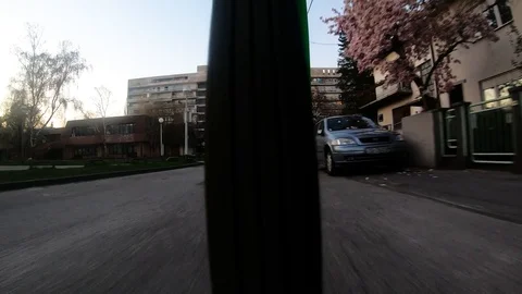 955_04 Bicycle Ride Wheel View With Car Coming Around The Corner Stock Footage 105223911