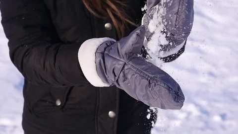 96 FPS slow motion close-up shot of a young girl brushing snow off her mittens Stock Footage 72658429