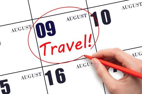9th day of August. Hand drawing a red circle and writing the text TRAVEL on t Stock Photos