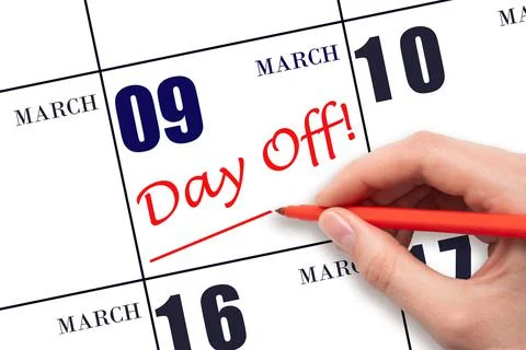 9th day of March. Hand writing text DAY OFF and drawing a line on calendar da Stock Photos