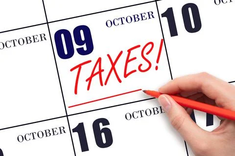 9th day of October. Hand drawing red line and writing the text Taxes on calen Stock Photos
