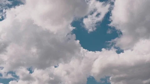 9Volumetric clouds fly fast in the blue sky, background for the design Stock Footage 128959005