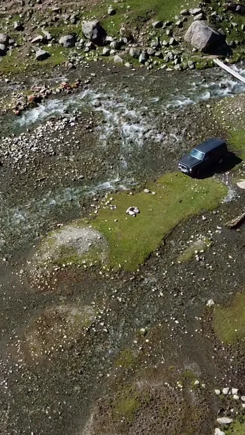 9x16: Top Down View Of SUV Crossing River. Kyrgyzstan, Suttuu-Bulak Lake. Stock-Footage 332787431