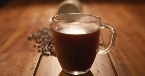 A009 C032 01098T 001 Pan Down to a Steaming Cup of Coffee Stock Footage 218340735