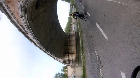 A0144 Rome A biker along the river Bicycle lane and bridge Vertical VR360 eff Stock Footage 107444619