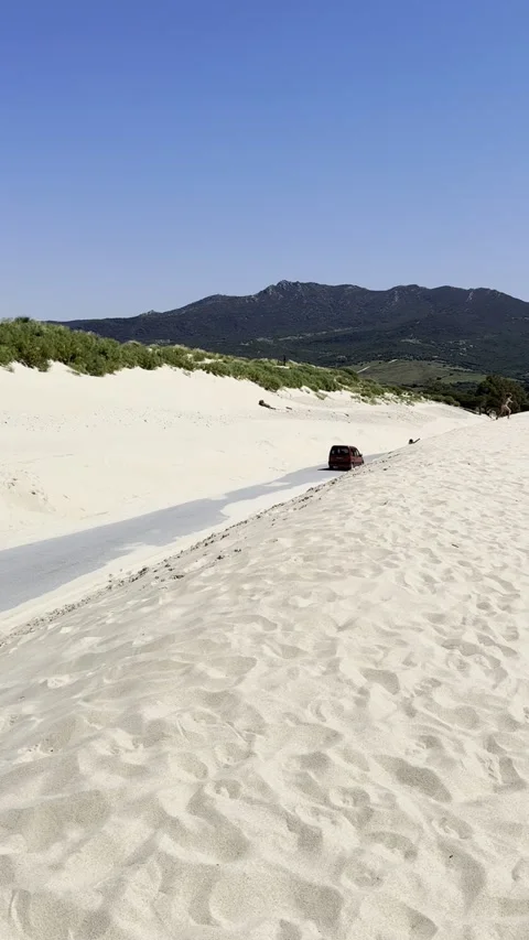 A2325 road surrounded by Wind-Formed Sand Dunes in Valdevaqueros Spain Stock Footage 311896751