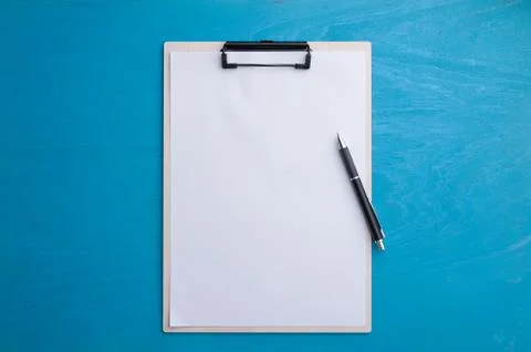 A4 clipboad on blue wood table Stock Photos