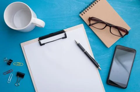 A4 clipboad on blue wood table Stock Photos