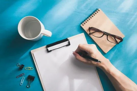 A4 clipboad on blue wood table Stock Photos