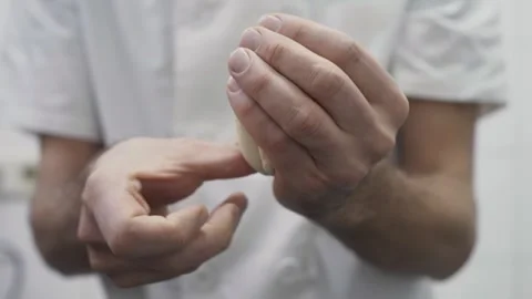 A4K. Baker handling and shaping piece of raw dough into a bun with two hands 스톡 동영상 251364071