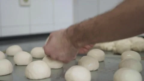 A4K. making bread, moistening bread rolls and sprinkling seeds of sesame Stock Footage 251364122