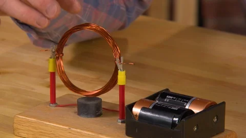 AA battery creates a magnetic field during experiment Stock Footage 99055628