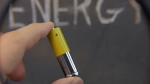 AA battery next to the power. Look through a magnifying glass Stock Footage 123754285