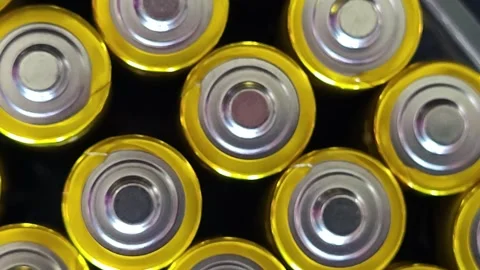 AA size batteries end on view rotating in front of camera Stock Footage 245505523