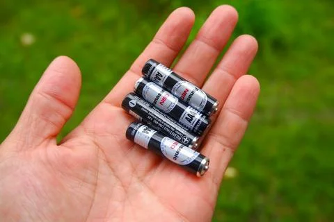AAA Battery in hand Stock-Fotos
