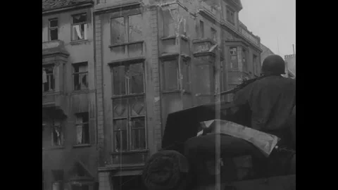AACHEN - 1944: Apartment interior view - Silhouetted helmets frame torn curtains Stock Footage 344005667
