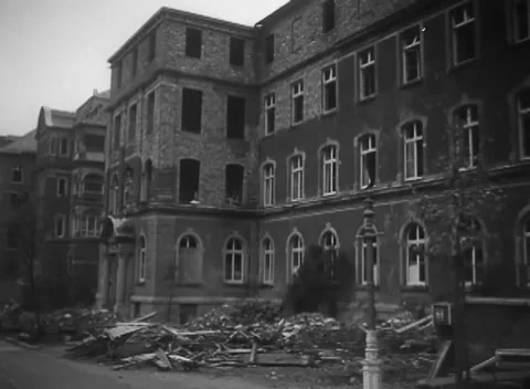 AACHEN, GERMANY - 1944: Rubble spill - spreads onto a panned street Stock Footage 344599593