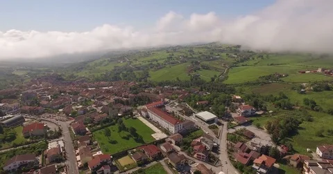 AAerial 4k drone shot above a beautiful small town with clouds and mountains Stock Footage 71157710
