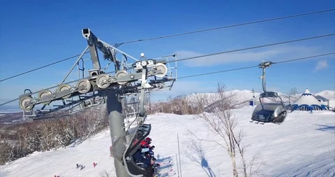 Aaerial view of ski lift elevator engine and people lifting in chair evelavor Stock Footage 88486168