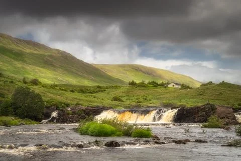 Aasleagh Falls on Erriff River with a single house under Letterass Mountains  Stock Photos