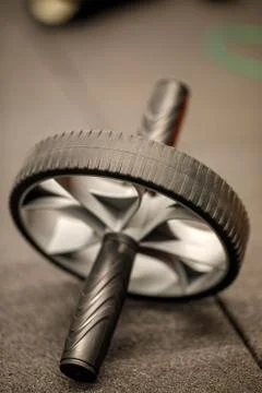Ab roller wheel used for exercising abdominal muscles. Workout fitness exerci Stock Photos