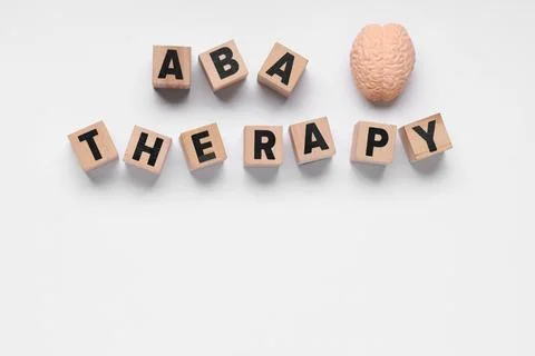 Aba therapy with brain model and wooden blocks on white background for autism Stock Photos