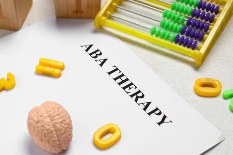 Aba therapy document with abacus, brain model, and educational toys for autis Stock Photos