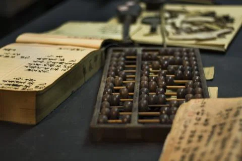 Abacus and book on the table Stock Photos