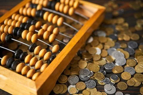 Abacus on coins background Stock Photos