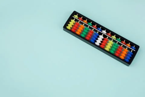 Abacus for mental arithmetic on a light blue background. Stock Photos