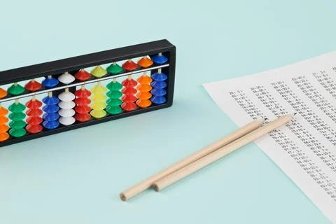 Abacus for mental arithmetic on a light blue background. Stock Photos