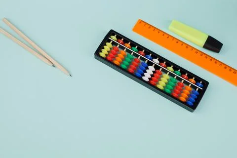 Abacus for mental arithmetic on a light blue background. Stock Photos