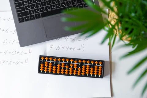 Abacus for mental arithmetic on a table with a laptop, nobody. The concept .. Stock Photos