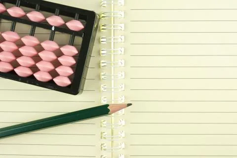 Abacus put on notebook with pencil Stock Photos