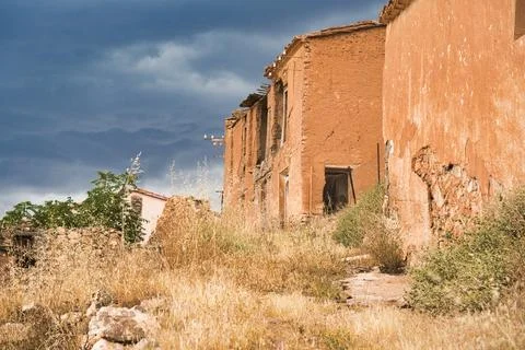 Abandoned adobe structure stands under a dramatic sky Stock Photos