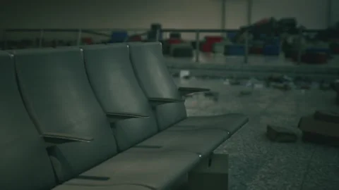 Abandoned airport interior with empty waiting area and scattered luggage Stock Footage 289075232