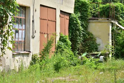 Abandoned and neglected building and garage. Summer. Day. Stock Photos