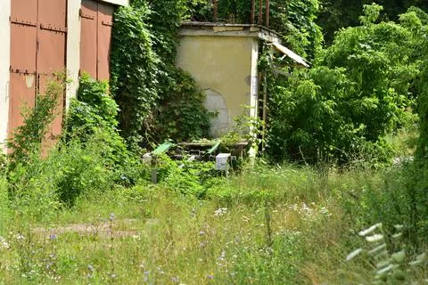 Abandoned and neglected building and garage. Summer. Day. Stock Photos