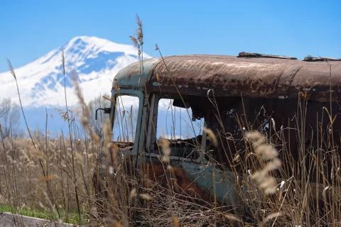 Abandoned and rusty old Soviet Russian bus in the middle of reeds Stock Photos