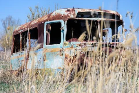 Abandoned and rusty old Soviet Russian bus in the middle of reeds Stock Photos