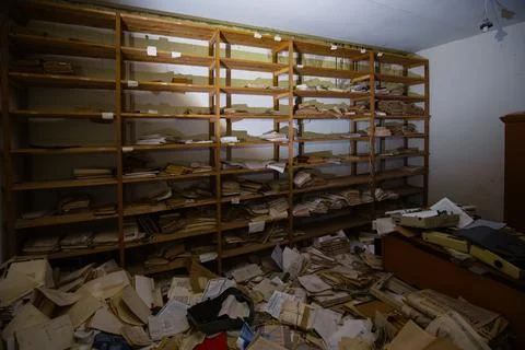Abandoned archive room. Old documents on shelves Stock Photos