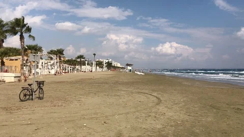 Abandoned Bicycle at the Beach with Couple walking Stock Footage 98177953