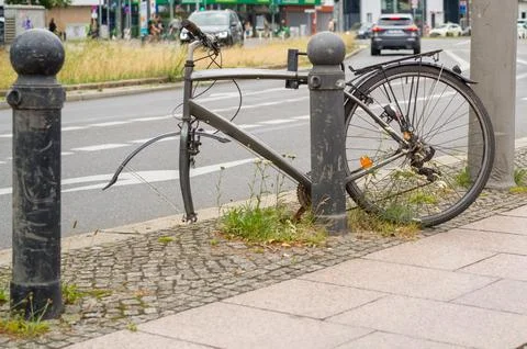 Abandoned bicycle missing its wheel. Stock Photos