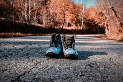 Abandoned Boots on Empty Road Stock Photos