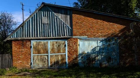 An Abandoned Brick Building Featuring Unique Blue Details and Features in a Stock Photos