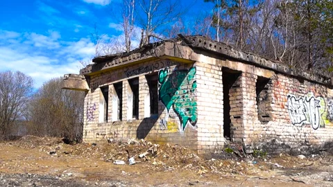 Abandoned Brick Building with Graffiti under Blue Sky Stock Footage 336652547