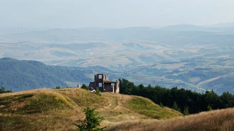 Abandoned brick building ruins on mountain peak overlooking valley Stock Footage 340462568