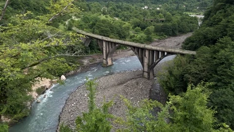 Abandoned Bridge Over Mountain River in Green Valley Stockbeeldmateriaal 300199521