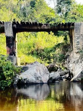 Abandoned bridge over stream Stock Photos